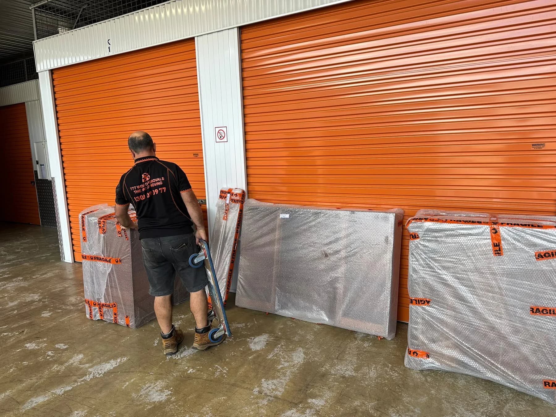 777 World Removals team member preparing wrapped furniture for storage