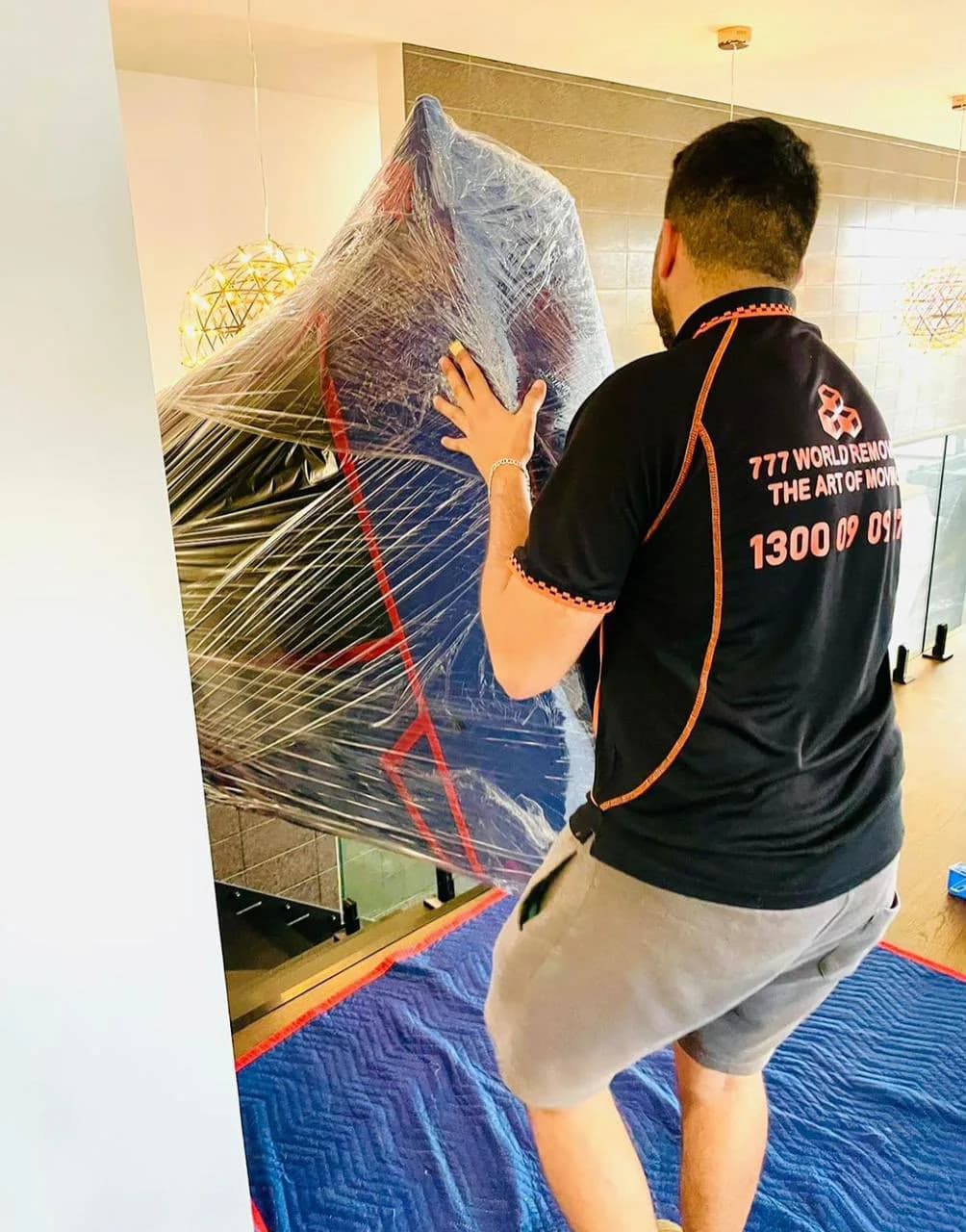 777 World Removals team member moving a carefully wrapped specialty item