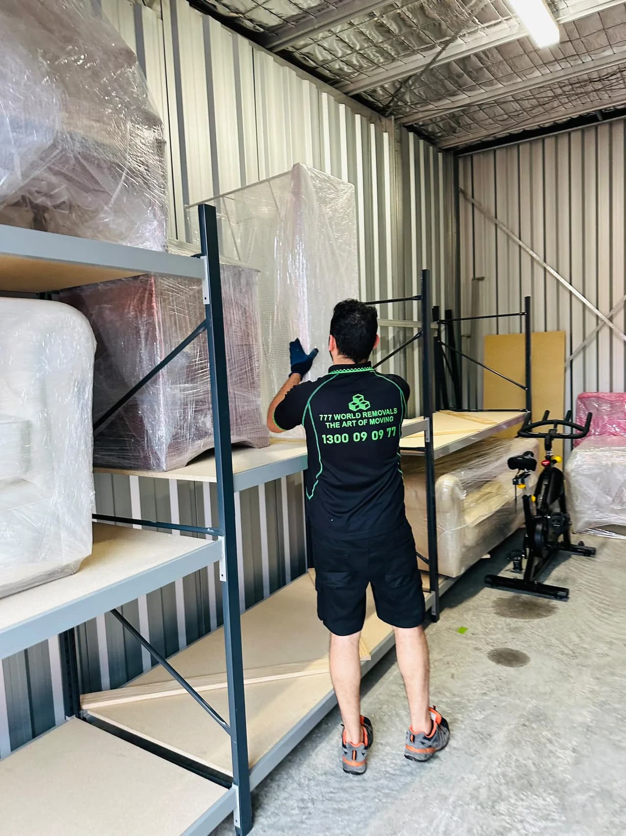 777 World Removals team member carefully storing wrapped furniture